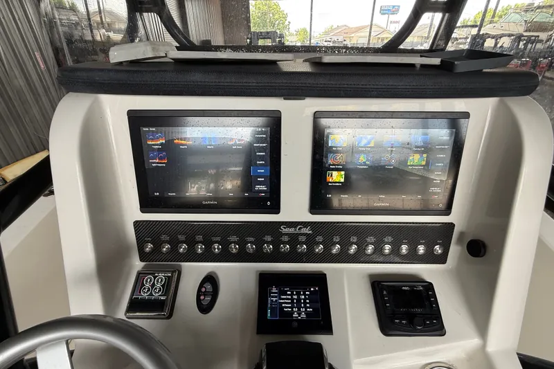 Slide: The Image of Control panel of 2021 Sea Cat 260 boat with dual Garmin displays. - 21