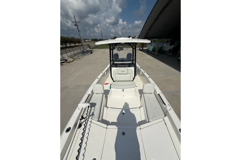 Slide: The Image of 2021 Sea Cat 260 boat with spacious deck and seating under cloudy sky. - 15