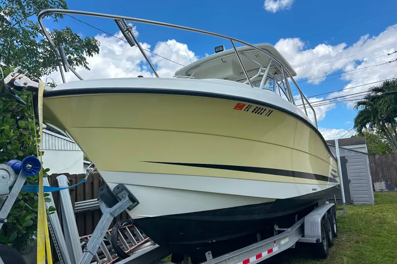 Slide: The Image of 2004 Hydra-Sports Vector 2800 WA boat on trailer, parked outdoors under blue sky. - 15