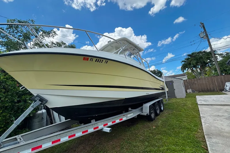 Slide: The Image of 2004 Hydra-Sports Vector 2800 WA boat on trailer, parked outdoors under a blue sky. - 14