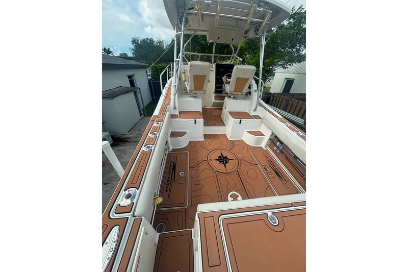 Slide: The Image of 2004 Hydra-Sports Vector 2800 WA boat deck with custom flooring and seating arrangement. - 17