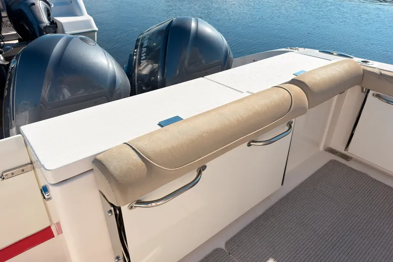 Slide: The Image of 2015 Pursuit DC 325 Dual Console boat with twin engines and cushioned seating. - 2