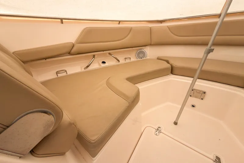 Slide: The Image of Interior of 2015 Pursuit DC 325 Dual Console boat with beige seating and storage. - 13