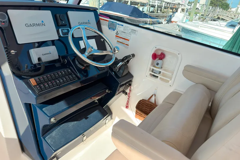 Slide: The Image of 2015 Pursuit DC 325 Dual Console helm with Garmin navigation system and leather seating. - 6