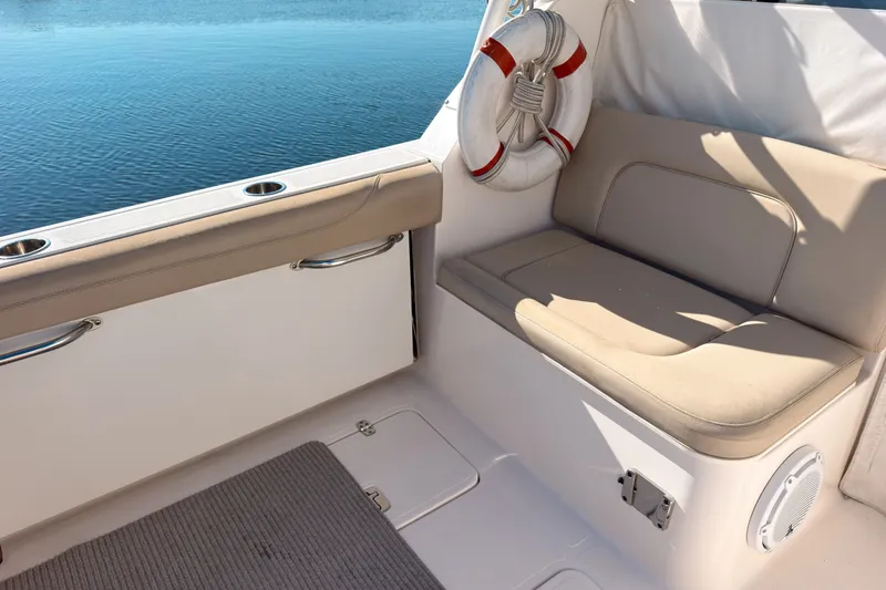 Slide: The Image of 2015 Pursuit DC 325 Dual Console boat interior with seating and life preserver. - 3