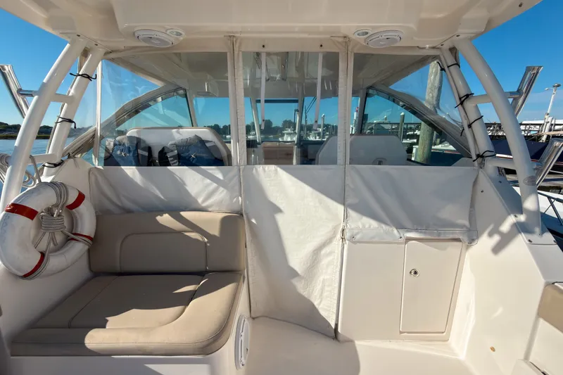 Slide: The Image of 2015 Pursuit DC 325 Dual Console boat interior with seating and life preserver. - 5