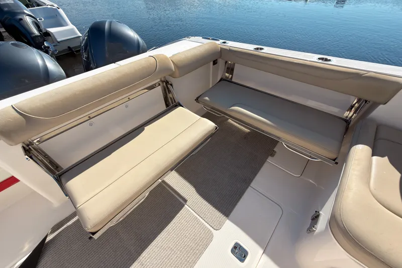Slide: The Image of 2015 Pursuit DC 325 Dual Console boat with beige seating and water view. - 4