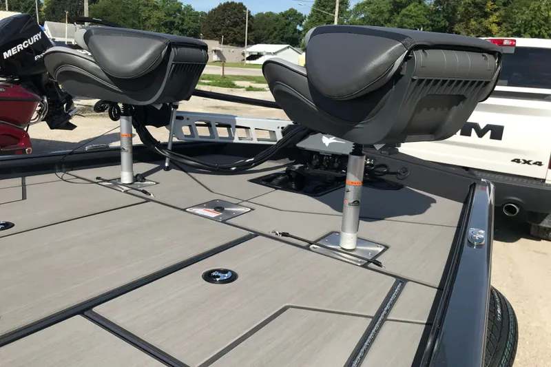 Slide: The Image of 2027 Lund 1875 Renegade boat deck with seating and Mercury engine in background. - 13