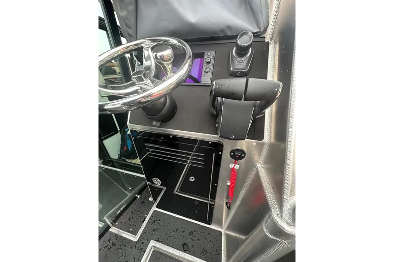 Slide: The Image of Control panel of 2023 Life Proof 41 full cabin boat with steering wheel and throttle. - 39