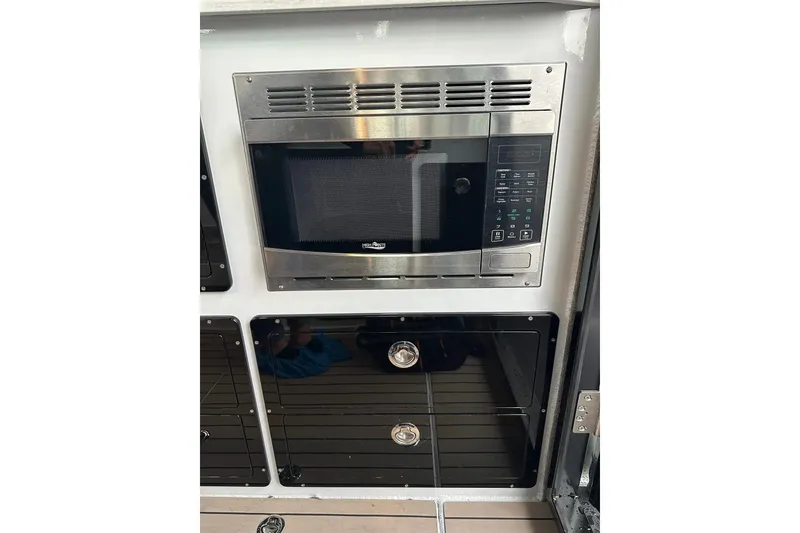 Slide: The Image of Built-in microwave and storage in 2023 Life Proof 41 full cabin boat kitchen. - 34