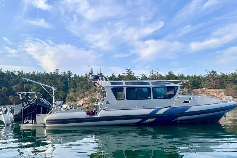 The Image of 2023 Life Proof 41 full cabin boat on calm water, surrounded by trees and blue sky. - 1