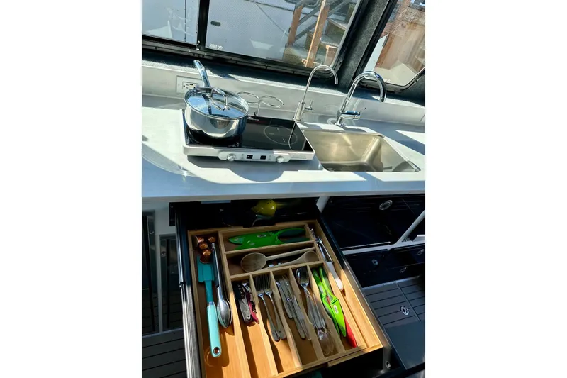 Slide: The Image of Modern kitchen setup in 2023 Life Proof 41 full cabin boat, featuring stove, sink, and organized utensils. - 18