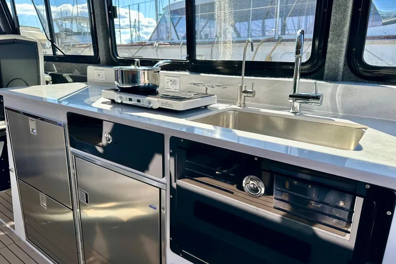 Slide: The Image of Modern kitchen in 2023 Life Proof 41 full cabin boat with stove and sink. - 17