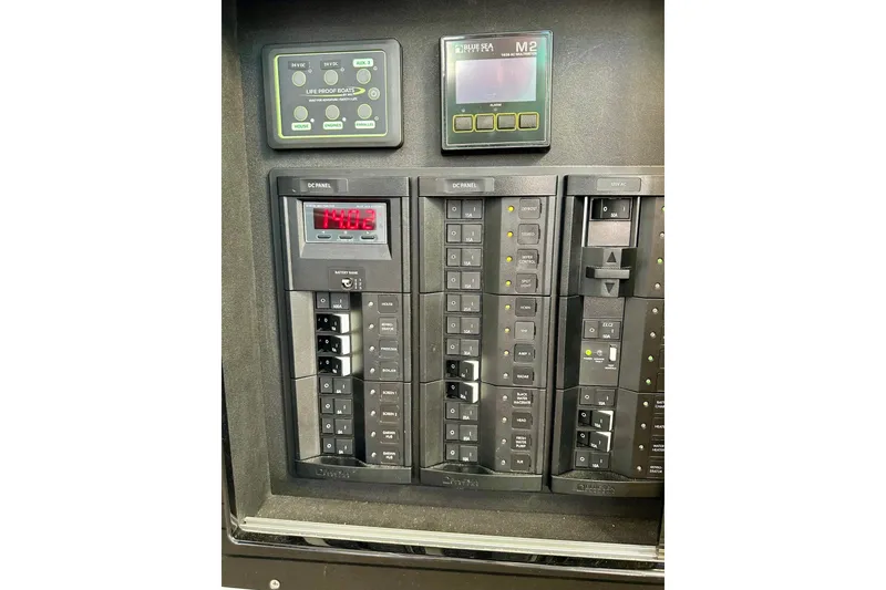 Slide: The Image of Electrical control panel of 2023 Life Proof 41 full cabin boat, featuring various switches and displays. - 11