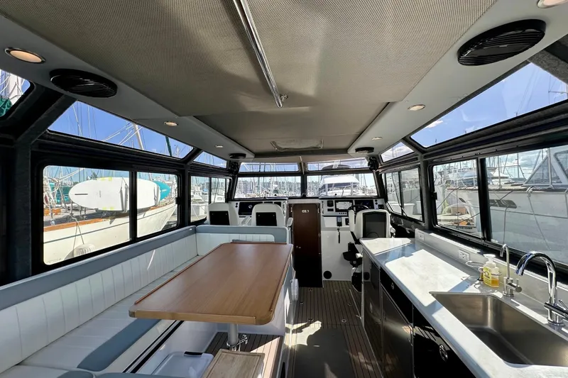 Slide: The Image of Interior of 2023 Life Proof 41 full cabin boat with modern seating and kitchen area. - 14