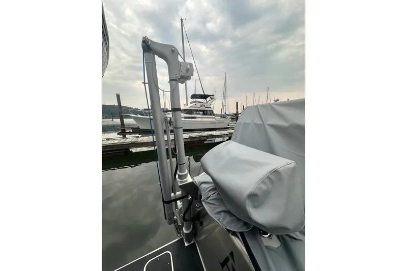 Slide: The Image of 2023 Life Proof 41 full cabin boat docked, featuring covered equipment and marina background. - 44