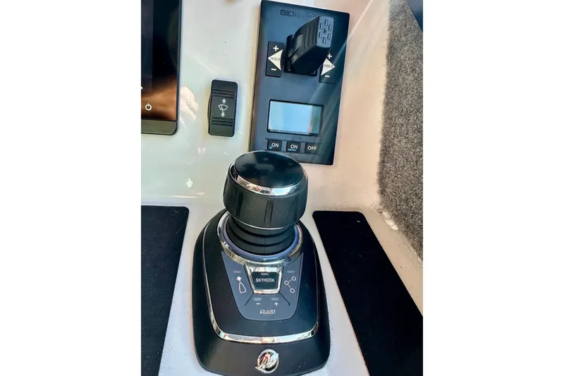 Slide: The Image of Control panel of 2023 Life Proof 41 full cabin boat, featuring joystick and switches. - 22