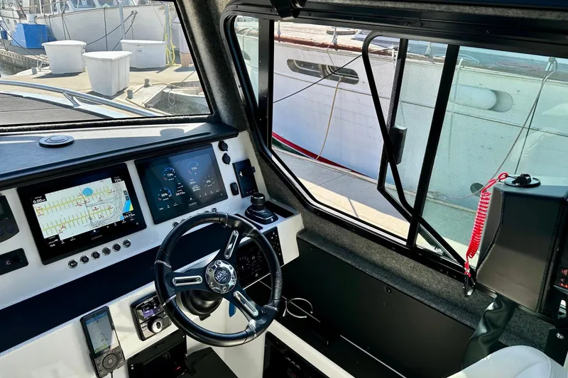Slide: The Image of Interior view of 2023 Life Proof 41 full cabin boat with navigation controls and dashboard. - 16