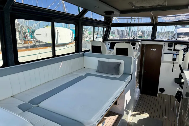 Slide: The Image of Interior of 2023 Life Proof 41 full cabin boat, featuring spacious seating and modern controls. - 12