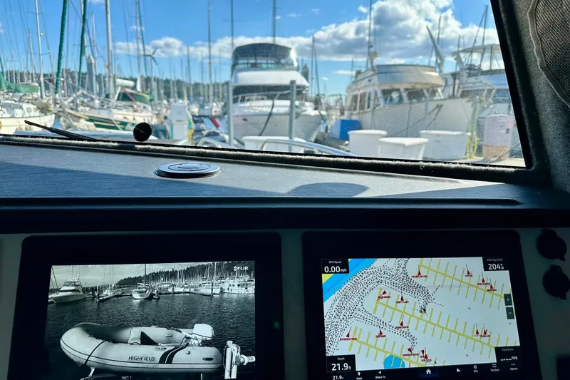 Slide: The Image of Interior view of 2023 Life Proof 41 full cabin boat with navigation screens and marina background. - 8