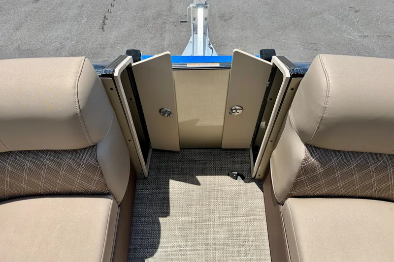 Slide: The Image of Interior view of a 2027 Vanderbilt 700T boat with beige seating and open storage compartments. - 13