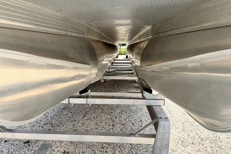 Slide: The Image of Underneath view of a 2027 Vanderbilt 700T pontoon boat on a trailer. - 34