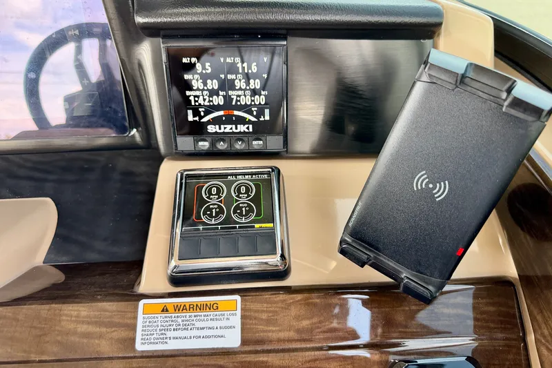 Slide: The Image of Dashboard of a 2027 Vanderbilt 700T boat with Suzuki controls and warning label. - 27