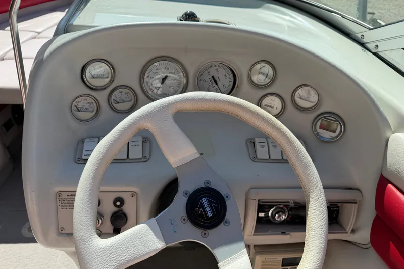 Slide: The Image of 2006 Crownline 266 BR boat dashboard with steering wheel and gauges. - 15