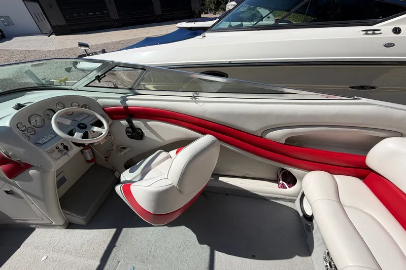 Slide: The Image of Interior of a 2006 Crownline 266 BR boat with red and white seating. - 8