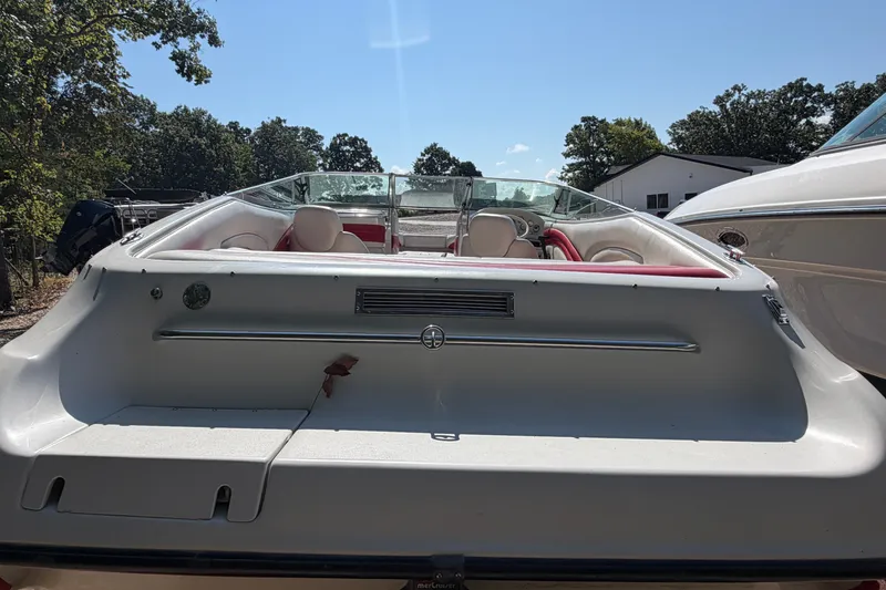 Slide: The Image of 2006 Crownline 266 BR boat with red and white interior, parked outdoors. - 5