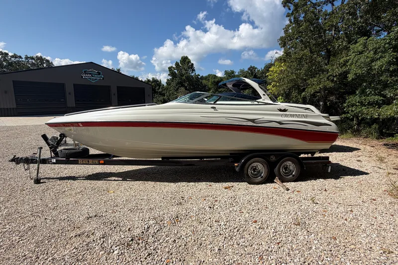 Slide: The Image of 2006 Crownline 266 BR boat on trailer, parked outdoors under a clear sky. - 3