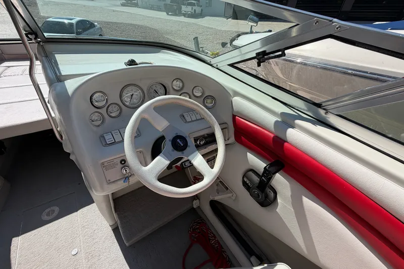 Slide: The Image of 2006 Crownline 266 BR boat dashboard with steering wheel and gauges. - 14