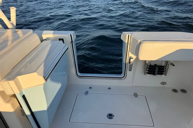 Slide: The Image of 2023 Cobia 330 Dual Console boat interior with open deck and ocean view. - 20