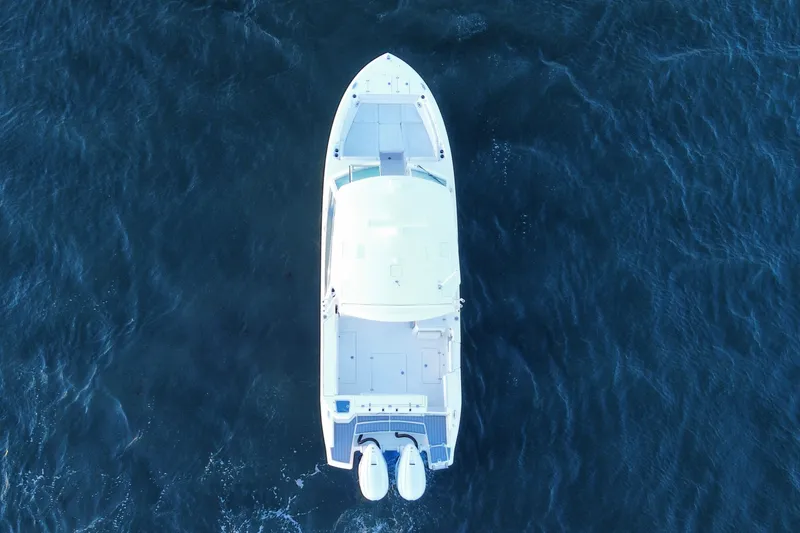 Slide: The Image of Aerial view of 2023 Cobia 330 Dual Console boat on open water. - 7