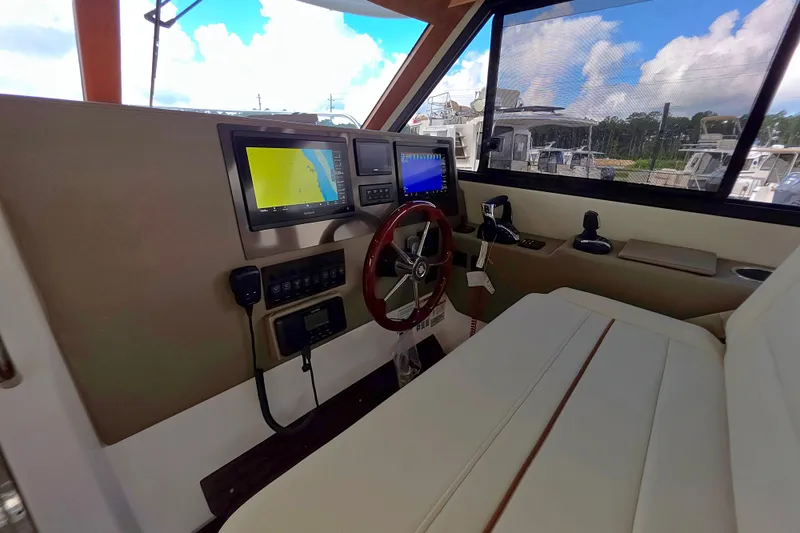 Slide: The Image of Interior cockpit of 2027 Cutwater C-32 Coupe with navigation screens and steering wheel. - 29