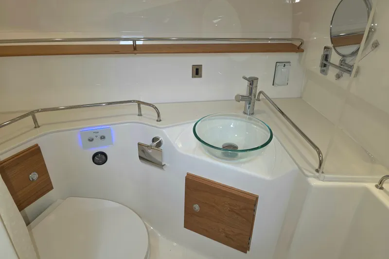 Slide: The Image of Modern bathroom interior of 2027 Cutwater C-32 Coupe with glass sink and sleek fixtures. - 24