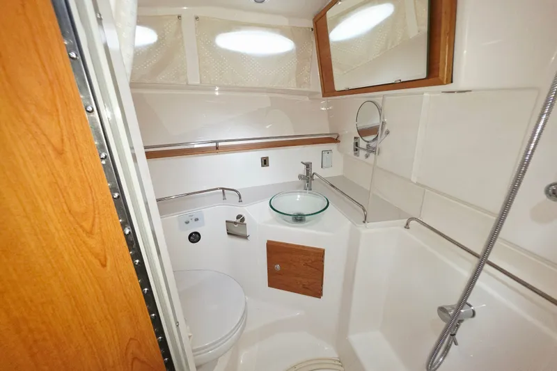 Slide: The Image of Modern bathroom in 2027 Cutwater C-32 Coupe boat with glass sink and shower. - 20