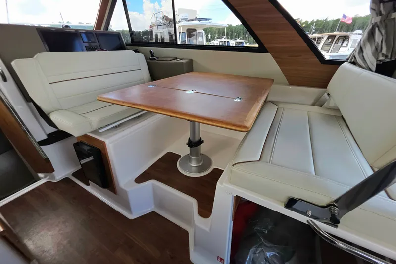 Slide: The Image of Interior of 2027 Cutwater C-32 Coupe with white seating and wooden table. - 16