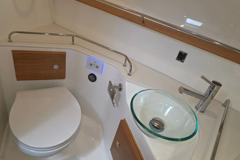 Slide: The Image of Luxurious bathroom in 2027 Cutwater C-32 Coupe with modern fixtures and glass sink. - 26