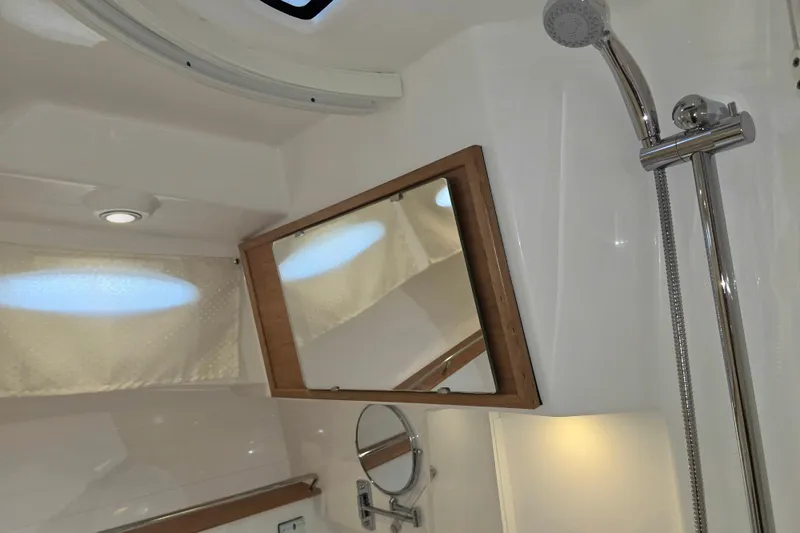 Slide: The Image of Interior of 2027 Cutwater C-32 Coupe bathroom with shower and mirror. - 25