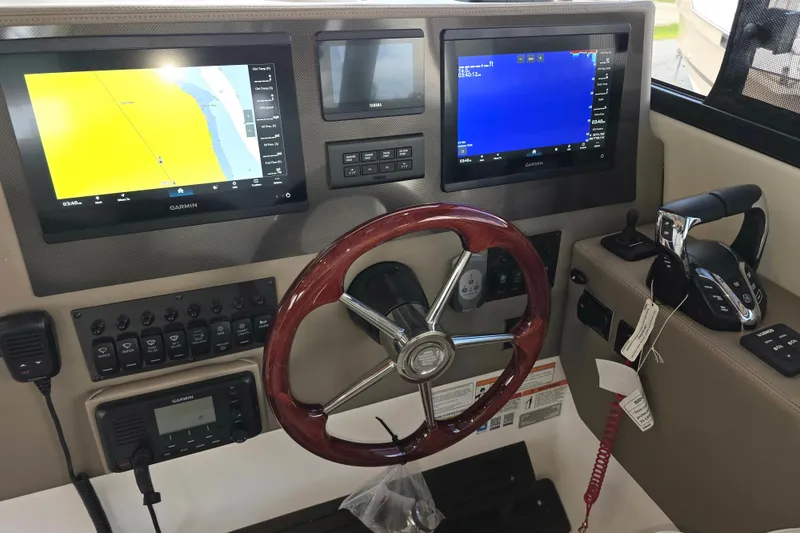 Slide: The Image of Helm of 2027 Cutwater C-32 Coupe with Garmin navigation displays and wooden steering wheel. - 23