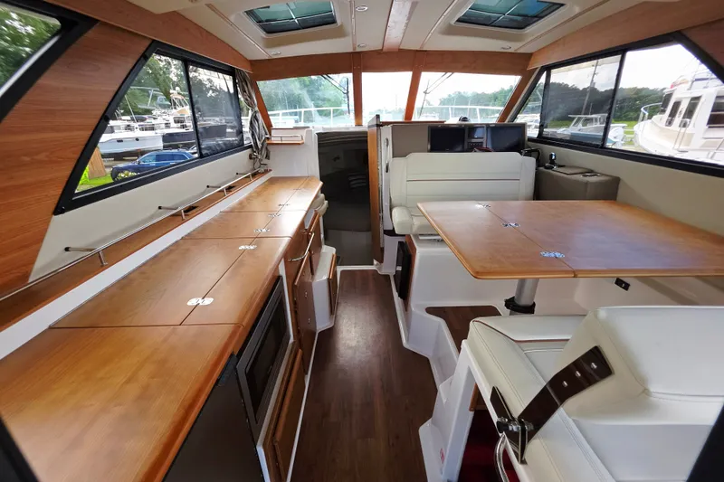 Slide: The Image of Interior of 2027 Cutwater C-32 Coupe, featuring elegant wood finishes and modern seating. - 17