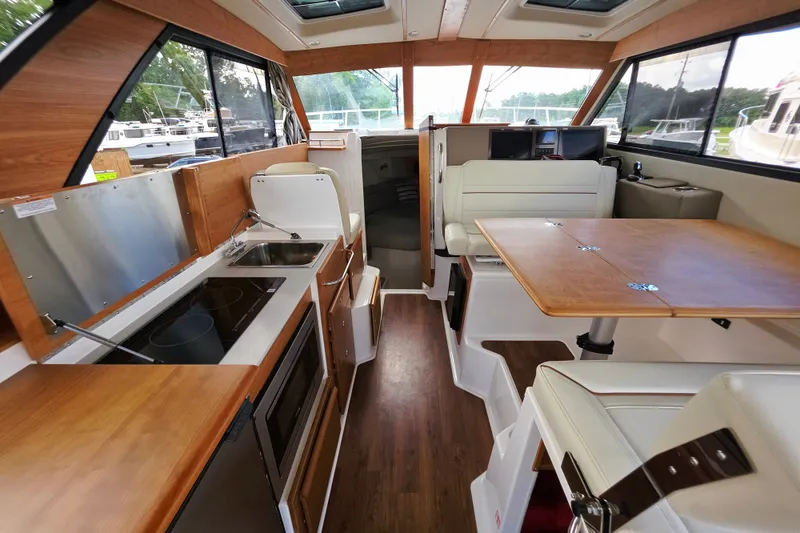 Slide: The Image of Interior of 2027 Cutwater C-32 Coupe, featuring modern kitchen and dining area. - 18