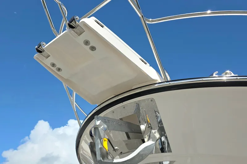 Slide: The Image of 2027 Cutwater C-32 Coupe boat anchor and bow against clear blue sky. - 36