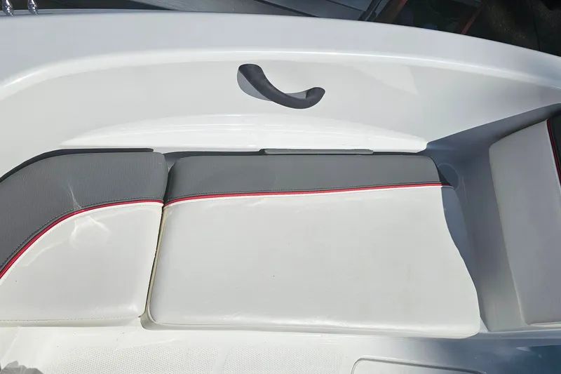 Slide: The Image of 2022 Tahoe T16 boat interior with white and gray seating, red trim accents. - 18