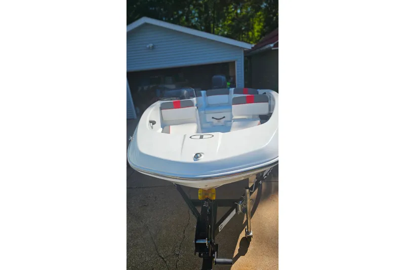 Slide: The Image of 2022 Tahoe T16 boat parked in driveway, featuring sleek design and comfortable seating. - 4