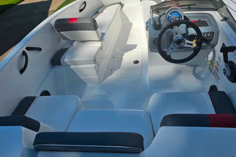 Slide: The Image of Interior of a 2022 Tahoe T16 boat, featuring seating and steering wheel. - 14