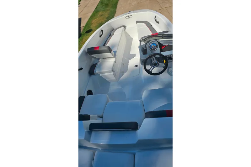 Slide: The Image of 2022 Tahoe T16 boat interior with steering wheel and seating arrangement. - 15