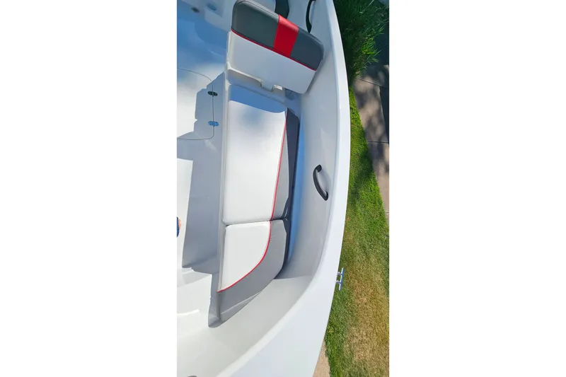 Slide: The Image of 2022 Tahoe T16 boat interior with red and gray seating. - 19