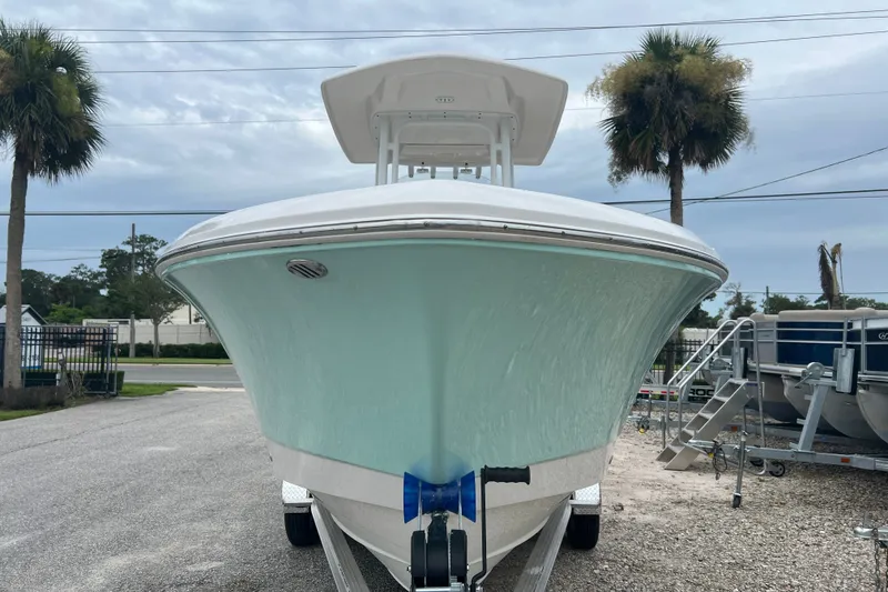 Slide: The Image of 2025 Robalo R230 Center Console boat on trailer, front view, outdoors. - 3